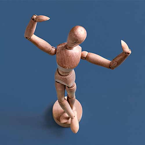 Wooden artists' mannequin with flexed arms on blue background