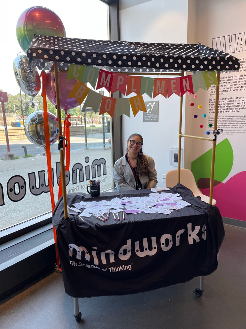 Research assistant Andrea Rivera-Martinez sits at the compliment booth