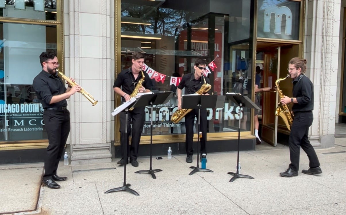 Saxophone quartet Nois performs on the sidewalk in front of Mindworks